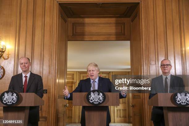 Boris Johnson, U.K. Prime minister, center, gestures during a news conference, flanked by Chris Whitty, U.K. Chief medical officer, left, and Patrick...