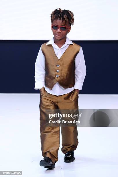 Model walks the runway wearing Wonderland Childrenswear during NYFW Powered By hiTechMODA on February 08, 2020 in New York City.