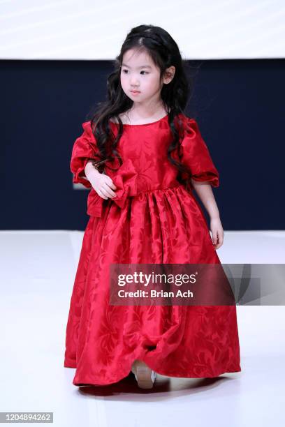 Model walks the runway wearing Wonderland Childrenswear during NYFW Powered By hiTechMODA on February 08, 2020 in New York City.