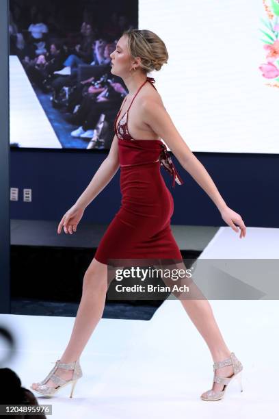 Model walks the runway wearing Camellia Couture during NYFW Powered By hiTechMODA on February 08, 2020 in New York City.