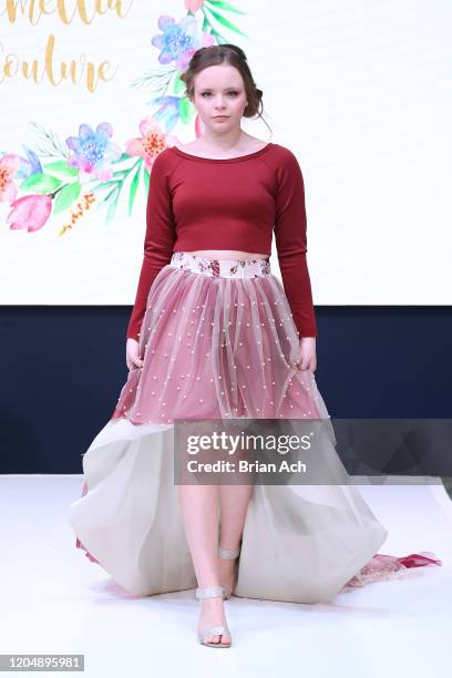 Model walks the runway wearing Camellia Couture during NYFW Powered By hiTechMODA on February 08, 2020 in New York City.