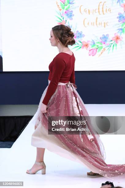 Model walks the runway wearing Camellia Couture during NYFW Powered By hiTechMODA on February 08, 2020 in New York City.