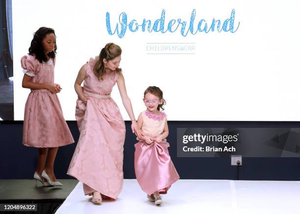 Model walks the runway wearing Wonderland Childrenswear during NYFW Powered By hiTechMODA on February 08, 2020 in New York City.