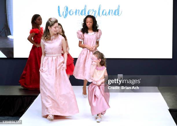 Model walks the runway wearing Wonderland Childrenswear during NYFW Powered By hiTechMODA on February 08, 2020 in New York City.