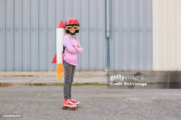 young girl wearing rocket and skates - launch of i believe you project stock pictures, royalty-free photos & images