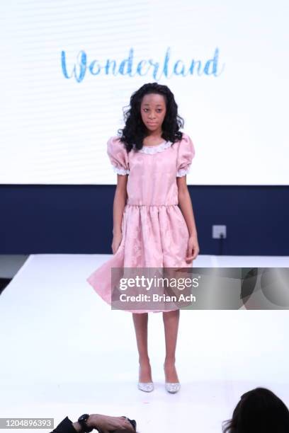 Model walks the runway wearing Wonderland Childrenswear during NYFW Powered By hiTechMODA on February 08, 2020 in New York City.