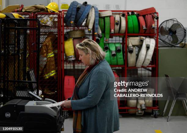 Woman casts her vote in the Virginia Democratic primary at the Philomont firehouse in Philomont, Virginia on March 3, 2020. Fourteen states and...