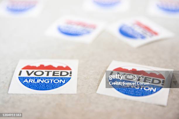 Arlington, VA I VOTED! stickers wait to be handed out to voters after they cast their ballots in the Democratic presidential primary elections at the...