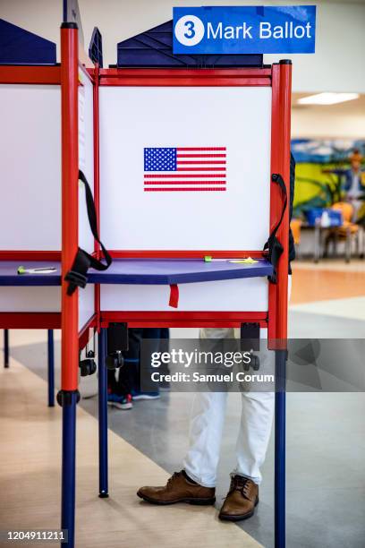 Arlington, VA A voter fills out his ballot during the Democratic presidential primary elections at the McKinley Elementary School polling location on...