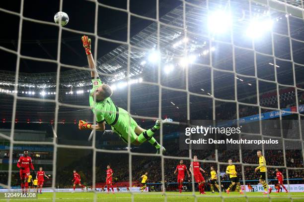 Emre Can of Borussia Dortmund scores his teams second goal past Goalkeeper, Lukas Hradecky of Bayer 04 Leverkusen during the Bundesliga match between...