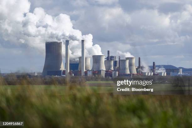 Cooling towers emit vapor at the Niederaussem lignite fueled power station, operated by RWE AG, in Bergheim Niederaussem, Germany, on Tuesday, March...