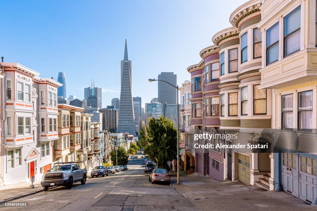 Street with residential district with skyscrapers of San Francisco financial district in the background, San Francisco, California, USA