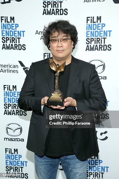 Bong Joon-ho poses in the press room with the Best International Film award for the film "Parasite" during the 2020 Film Independent Spirit Awards on...