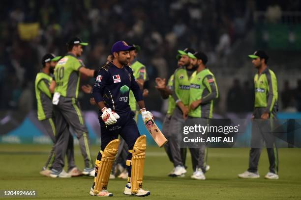 Quetta Gladiators' captain Sarfraz Ahmed walks off after his dismissal during the Pakistan Super League T20 cricket match between Lahore Qalandars...