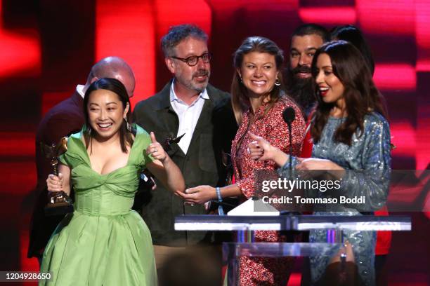 Host Aubrey Plaza watches Lulu Wang, Peter Saraf, Daniele Tate Melia, and Andrew Miano accept the Best Feature award for 'The Farewell' onstage...