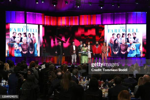 Robert De Niro listens while Eddie Rubin, Peter Saraf, Lulu Wang, Anita Gou, Andrew Miano, and Daniele Tate Melia accept the Best Feature award for...