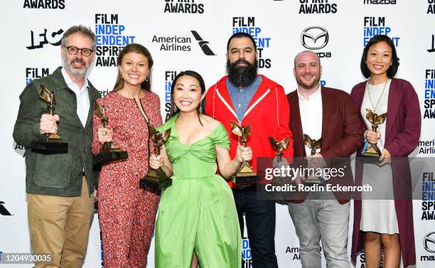 Peter Saraf, Daniele Tate Melia, Lulu Wang, Andrew Miano, a guest, and Anita Gou, winners of Best Feature for "The Farewell," pose in the press room...