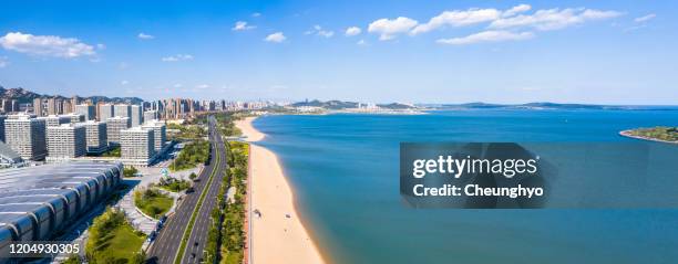 drone aerial view of the cityscape on the west coast of qingdao - oriental movie metropolis stock pictures, royalty-free photos & images