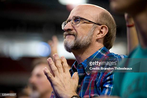 John Crouse stands praying in a crowd of attendees as they dance and sing during the non-denominational prayer and fasting event, entitled "The...