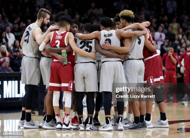 Members of the Colorado Buffaloes and the Stanford Cardinal huddle together after a collision between Evan Battey of the Colorado Buffaloes and Oscar...