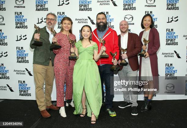 Peter Saraf, Daniele Tate Melia, Lulu Wang, Andrew Miano, a guest, and Anita Gou, winners of Best Feature for "The Farewell" pose in the press room...