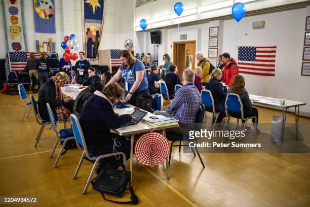 Voters are seen inside a polling station on Super Tuesday on March 3, 2020 in London, England. 1,357 Democratic delegates are at stake as voters cast...