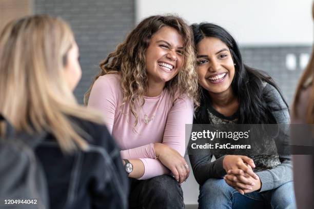 two girls sharing an embrace stock photo - bem estar mental imagens e fotografias de stock