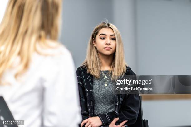 angry young girl in a counseling session stock photo - angery stock pictures, royalty-free photos & images