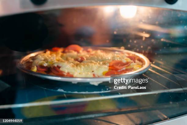 pizza baked in a microwave - microwave dish stock pictures, royalty-free photos & images