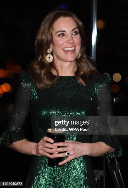 Catherine, Duchess of Cambridge drinks a pint of Guinness during a reception with Prince William, Duke of Cambridge, hosted by the British Ambassador...