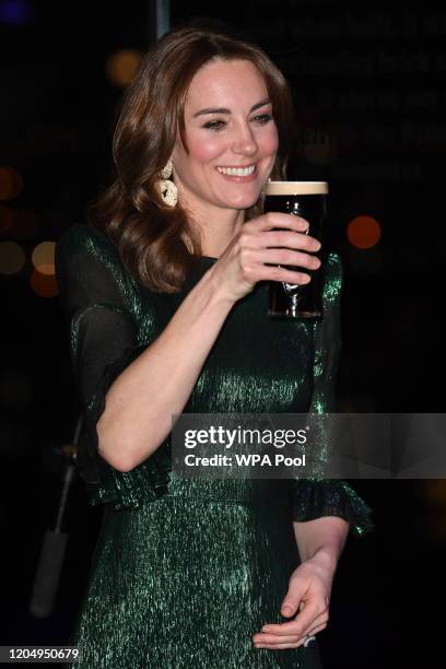 Catherine, Duchess of Cambridge drinks a pint of Guinness during a reception with Prince William, Duke of Cambridge, hosted by the British Ambassador...