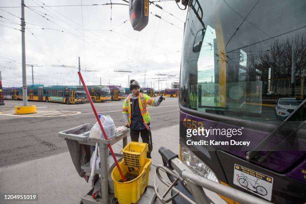 Tyler Goodwin, a utility service worker for King County Metro Transit, deep cleans a bus as part of its usual cleaning routine at the King County...
