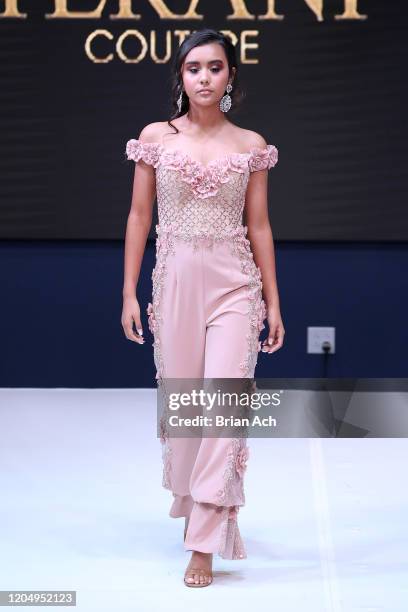 Model walks the runway wearing Bebe's and Liz's presents TERANI Couture during NYFW Powered By hiTechMODA on February 08, 2020 in New York City.