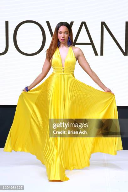 Model walks the runway wearing Bebe's and Liz's presents JOVANI during NYFW Powered By hiTechMODA on February 08, 2020 in New York City.