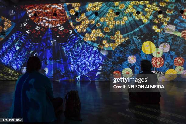 Visitors watch the multimedia installation during the "Japao em Sonhos" exhibition at the Japan House, in Sao Paulo, Brazil, on March 3, 2020.