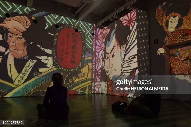 Visitors watch the multimedia installation during the "Japao em Sonhos" exhibition at the Japan House, in Sao Paulo, Brazil, on March 3, 2020.