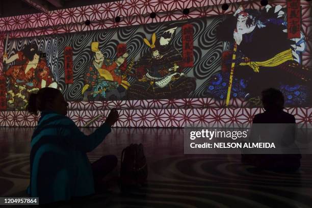 Visitors watch the multimedia installation during the "Japao em Sonhos" exhibition at the Japan House, in Sao Paulo, Brazil, on March 3, 2020.