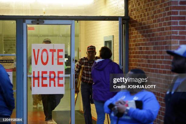 Voters exit a polling station at the National Guard Military Base during the presidential primary in Camden, Alabama on Super Tuesday, March 3, 2020....