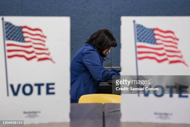 Voter fills in her ballots for the Democratic presidential primary election at a polling place in Armstrong Elementary School on Super Tuesday, March...