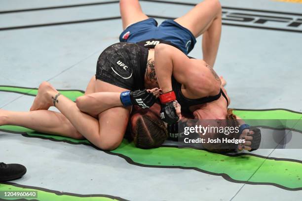 Valentina Shevchenko of Kyrgyzstan punches Katlyn Chookagian in their women's flyweight championship bout during the UFC 247 event at Toyota Center...