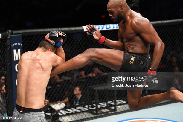 Jon Jones kicks Dominick Reyes in their light heavyweight championship bout during the UFC 247 event at Toyota Center on February 08, 2020 in...