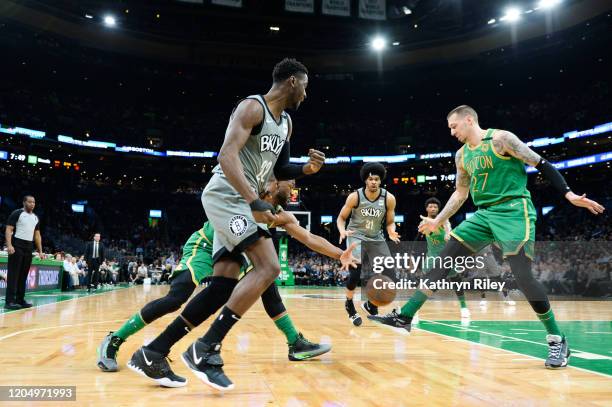 Daniel Theis of the Boston Celtics kicks the ball away from Spencer Dinwiddie of the Brooklyn Nets in the first half at TD Garden on March 3, 2020 in...