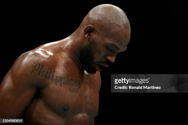 Jon Jones walks to his corner in between rounds against Dominick Reyes in their UFC Light Heavyweight Championship bout during UFC 247 at Toyota...
