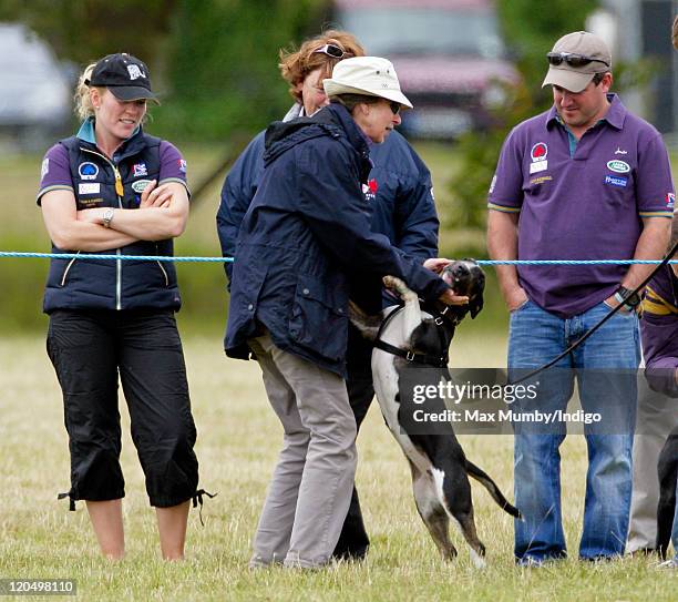 Autumn Phillips and Linda Tindall look on as Princess Anne, The Princess Royal plays with a dog as they attend day 2 of The Festival of British...