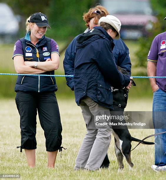 Autumn Phillips and Linda Tindall look on as Princess Anne, The Princess Royal plays with a dog as they attend day 2 of The Festival of British...