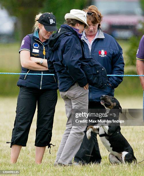 Autumn Phillips and Linda Tindall look on as Princess Anne, The Princess Royal plays with a dog as they attend day 2 of The Festival of British...