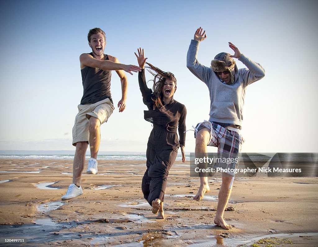 Three young adults enjoying on beach