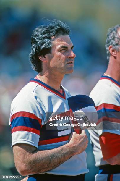 Manager Tony La Russa of the Chicago White Sox looks on from the field during the playing of the National Anthem before a spring training game...