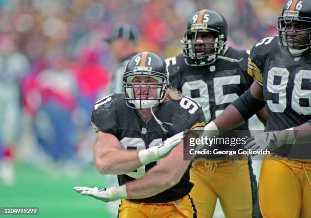 Linebacker Kevin Greene of the Pittsburgh Steelers celebrates after a play as linebacker Greg Lloyd and defensive lineman Brentson Buckner look on...
