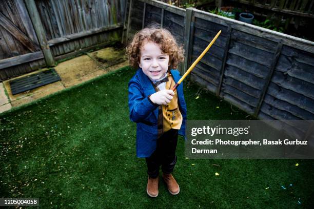 kid acting, making magic tricks - kid doing magic trick stock pictures, royalty-free photos & images